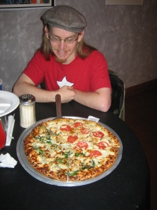 Erik stares at an Austin Riley's pizza